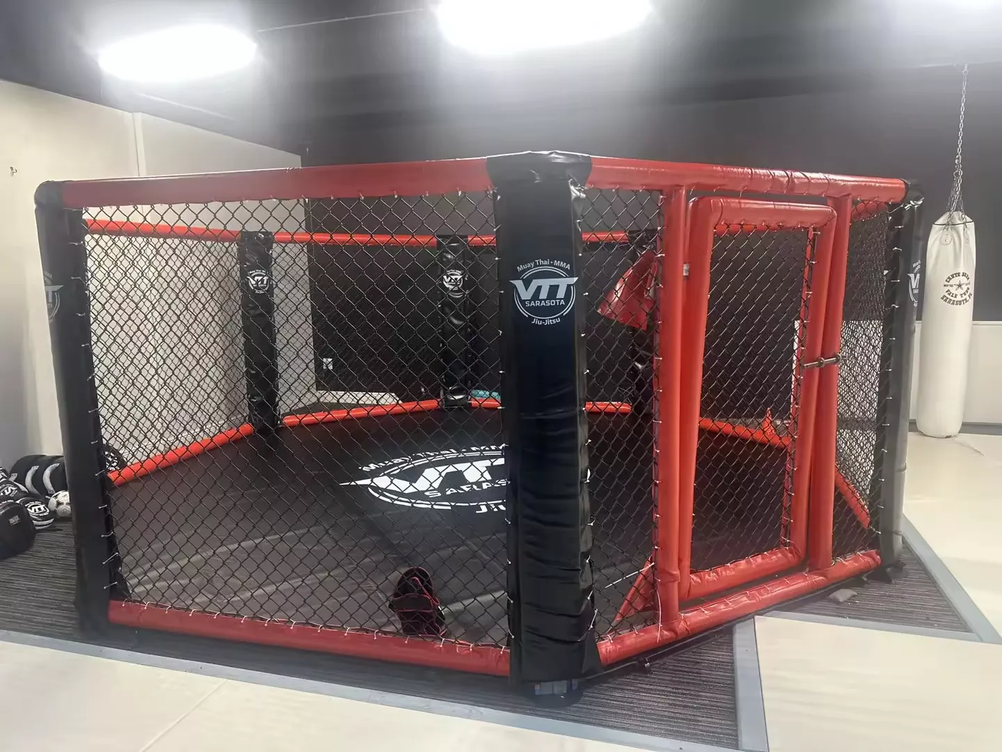 Custom MMA octagon installed at VTT Sarasota with branded padding and mat graphics